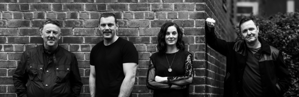 Black and white shot of the Outwalker Whiskey team against a brick wall.