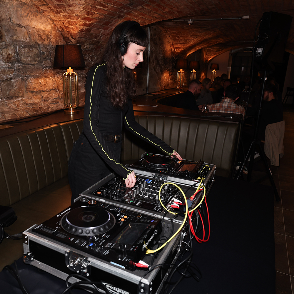 A woman DJ at an event.